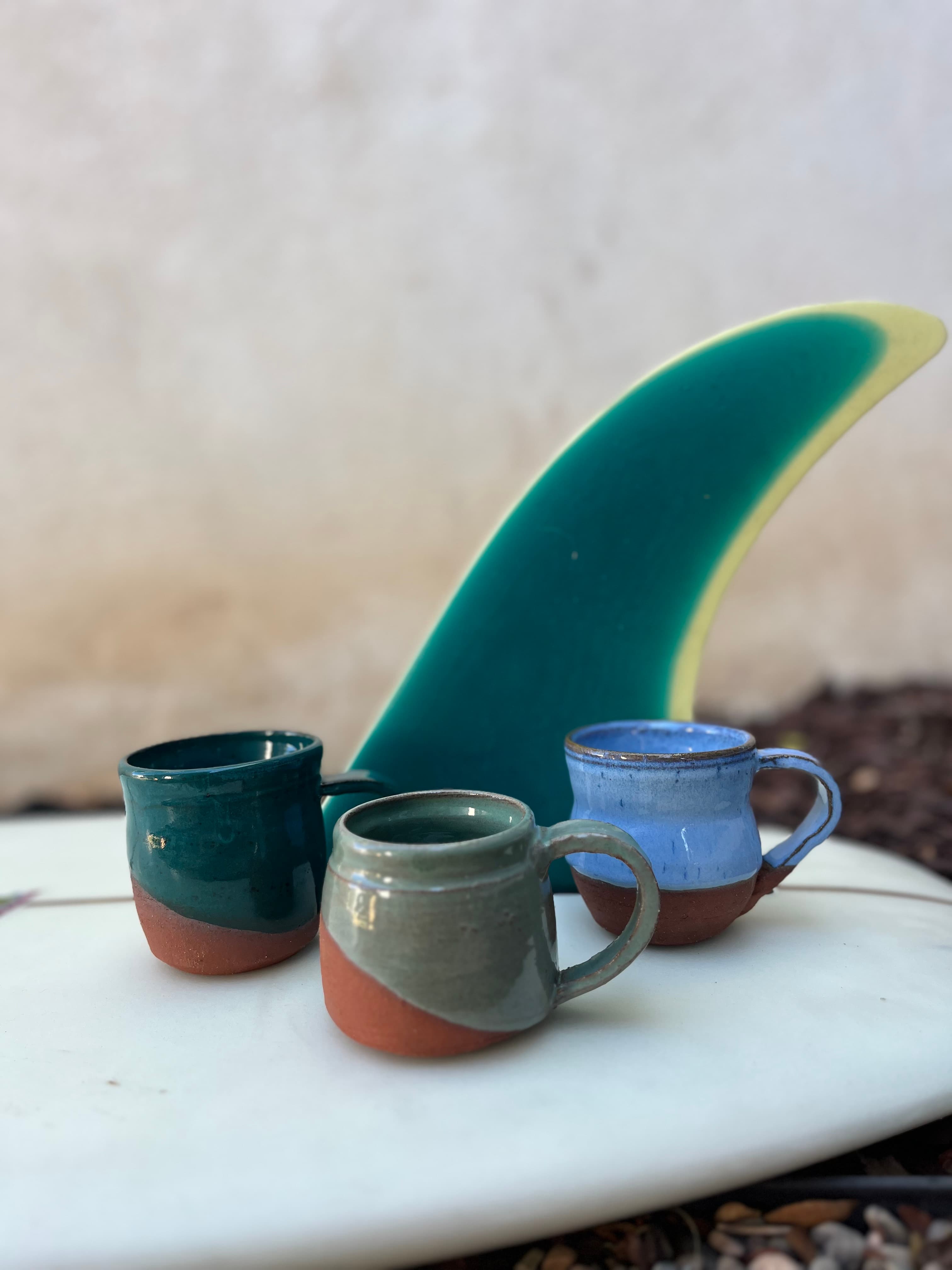 Handmade mugs with surfboard fin