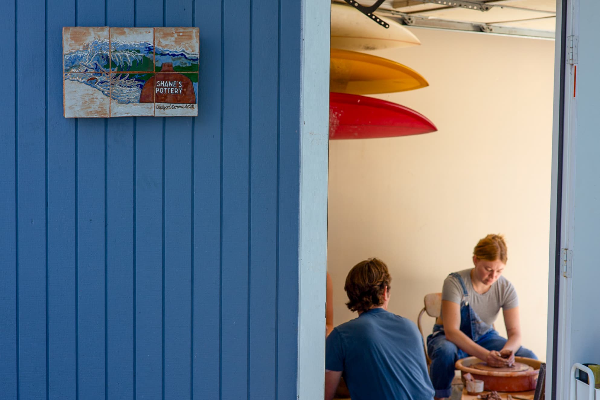 Blue studio building with Shane's Pottery ceramic sign